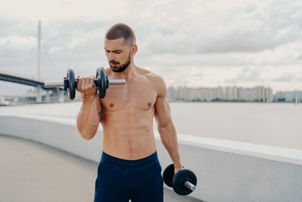focused man lifting dumbbell