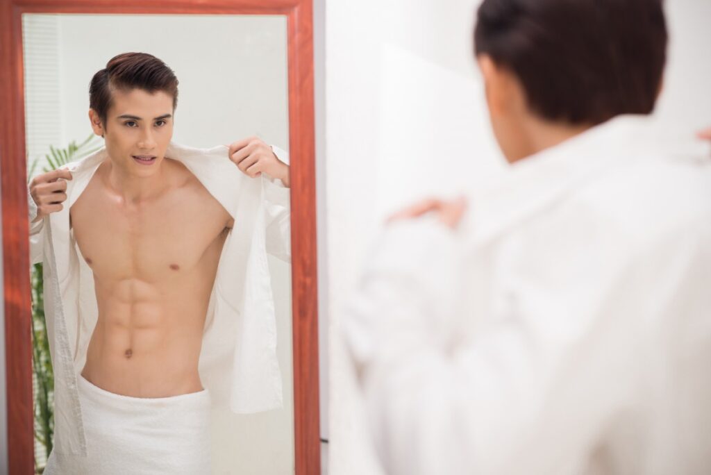 man looking at mirror physique