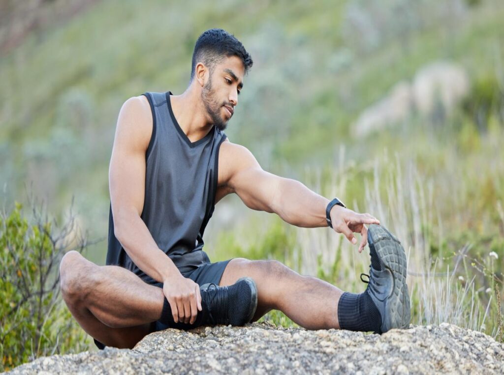 muscle recovery rest day fitness man stretching relaxation